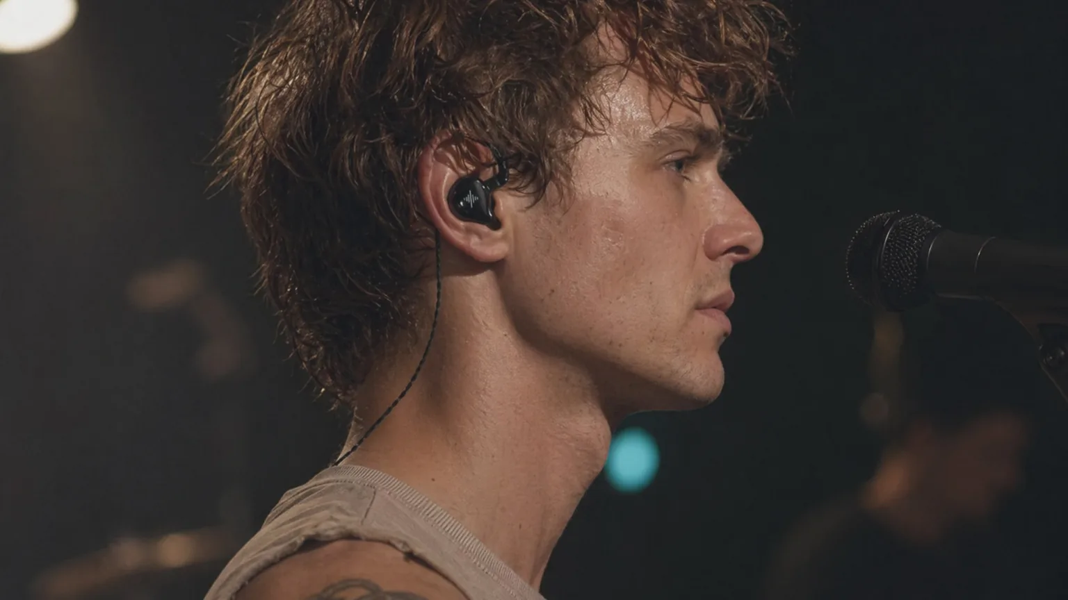 Singer wearing Soundbrenner Wave in-ear monitors on stage